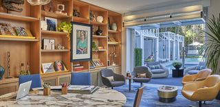 An art room at Viceroy Santa Monica with a marble table and chairs.