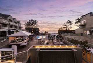 L'Auberge hotel pool with gorgeous purple sunset