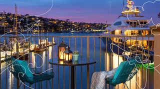 Suite balcony overlooking marina with yacht