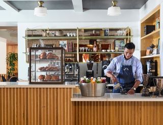 A barista making a drink at LAAC's Famous Players, a café and restaurant.