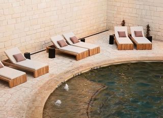 Pool with chairs surrounding.