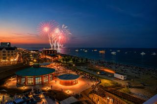 Fireworks over the boardwalk and beach.